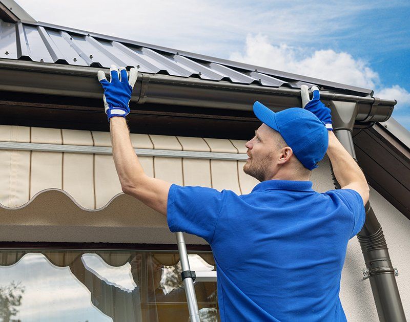 Worker Installing New Gutter